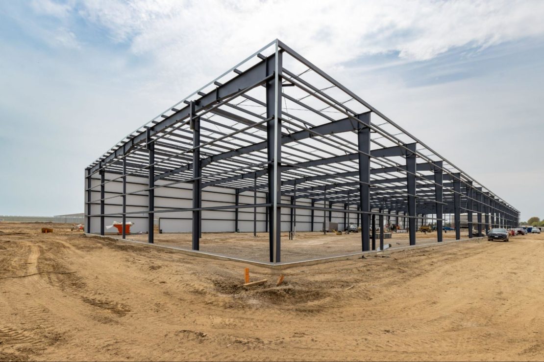 Vegetable greenhouse frame with end wall under construction.