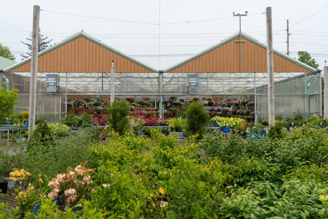Large sliding doors on a Vail greenhouses make it easy for customers to access outdoor shopping areas.